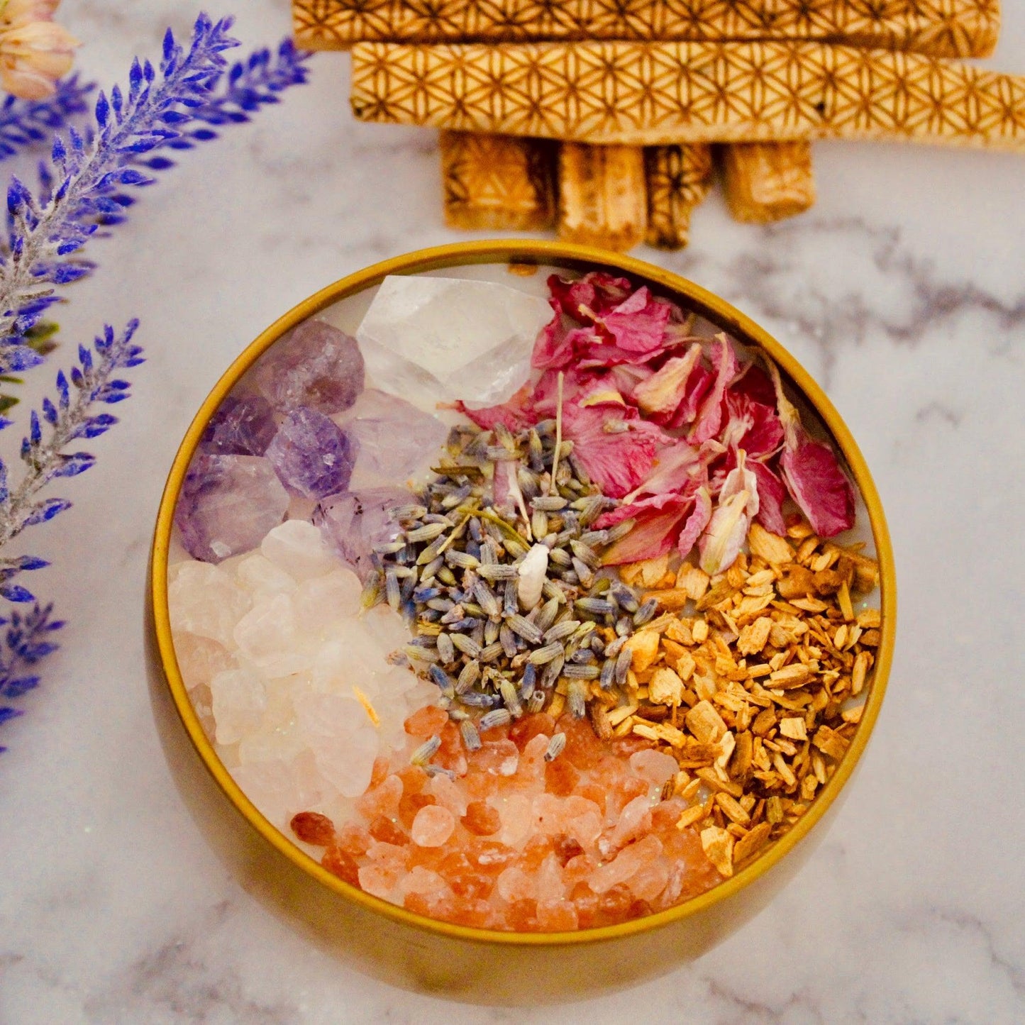 Ultimate Healer Crystal Candle in a sleek gold tin container, adorned with rose quartz and amethyst stones, designed to promote purity, peace, and love. Also empowered with lavender, rose, palo santo, and more. Bath and Body Works Pure Paradise replica scent. Available in two sizes: 4oz and 8oz.